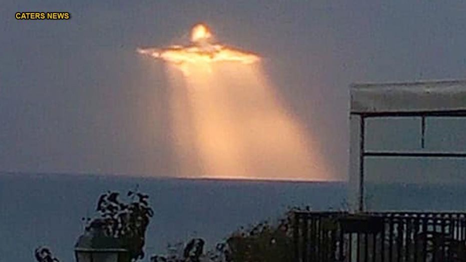 Image of Jesus Shining through the Clouds during Sunset and Captured on Camera